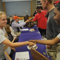 Fayetteville High seniors Kate Bucknam, left, and Stephen Soerens, wearing the ballcap, are congratu...