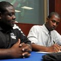 Springdale Har-Ber senior Phillip Mason, right, signs a letter of intent to wrestle for Central Bapt...