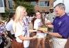Former fayetteville girls basketball coach Bobby Smith, right, along with senior guards Clair Childers, center, and Calli Berna and other members of the Lady Bulldogs team, admires a trophy from MaxPreps as presented by Master Sgt. Thomas Aldridge, rear, of the Arkansas Army National Guard on Wednesday on the Fayetteville square.