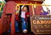 Northside Elementary School students Taylor Wright, left, and Riley Laxton check out the Centennial Caboose at Frisco Park in downtown Rogers. The caboose might be the solution to a mystery for Rogers Historical Museum’s new History Detectives club for kids.