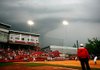 Farmington’s Payton Wiedner is tagged out by Ashdown catcher Danielle Winters during the third inning of the Class 4A state championship at Bogle Park in Fayetteville on Friday. The game was postponed after a 40-minute rain delay in the seventh inning and will resume today at 9 a.m. 