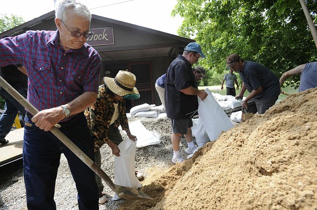 jim-and-ellie-cooper-of-mountain-home-and-other-volunteers-fill-sandbags-tuesday-in-cotter-where-record-water-releases-from-bull-shoals-dam-threatened-to-flood-homes-and-businesses