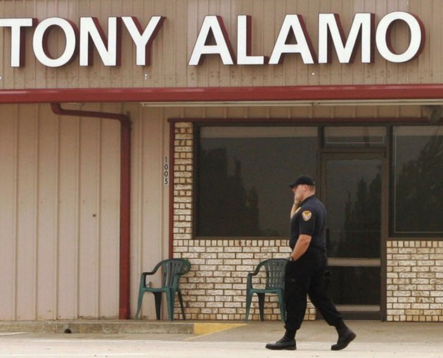 in-this-sept-21-2008-file-photo-a-man-patrols-in-front-of-the-tony-alamo-christian-church-in-fouke