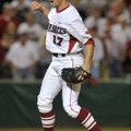 Arkansas reliever Barrett Astin reacts after throwing the final pitch of the Razorbacks’ win over Fl...