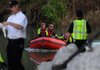 Rescue workers with the Highfill Swift Water Rescue Team return to a boat launch ramp Thursday, June 2, 2011, on the Illinois River near Siloam Springs after recovering a body from the river. Authorities believe the body to be that of Laura Lopez-Gomez, a missing flood victim.