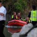 Rescue workers with the Highfill Swift Water Rescue Team return to a boat launch ramp Thursday, June...