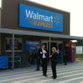 People walk in front of a yet-to-open Wal-Mart Express store in Gentry, Ark., Thursday, June 2, 2011...