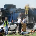 Bentonville firefighters work to contain a smoldering fire Friday in a burning Allied Waste Services...