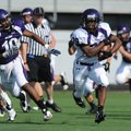Fayetteville senior running back Deshunn Thomas carries the ball as senior defender Casey Perry, lef...