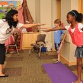 INTERNATIONAL DAY Pooja Agarwal, from left, gives a yoga lesson Saturday to Aurick Schmidt, 9, and G...