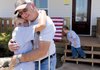 Dale “Lee” Walker Jr. gets a hug from his niece, Nakita Crittenden, 11, during a dedication ceremony Saturday for Walker’s new home near the Cincinnati community in Siloam Springs. The Walkers’ home was destroyed by a Dec. 31 tornado and was rebuilt by Heroes at Home and Rebuilding Together.
