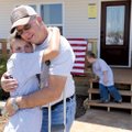 Dale “Lee” Walker Jr. gets a hug from his niece, Nakita Crittenden, 11, during a dedication ceremony...