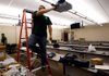 Justin Alvarado with Ford Audio and Video sets up a projector Wednesday in a classroom for the College of Pharmacy inside the University of Arkansas for Medical Sciences in the former Washington Regional Hospital in Fayetteville.