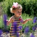 Holdyn Bryant, 2, of Little Rock flaps her arms like a butterfly Sunday while exploring the Botanica...