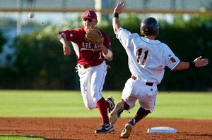 Special to the Arkansas Democrat-Gazette/DAVE CRUZ - 6/5/2011 - Arkansas second baseman Bo Bigham turns a double play during the Razorbacks' 13-4 loss to Arizona State Sunday night at Packard Stadium in Tempe, Ariz.