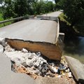 The roadway is washed out Thursday leading up to a bridge that crossing an unnamed creek along East ...