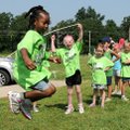 Kindergartner Kymberlyn Ware jumps high to skip a rope during a Fun and Field Day at Central Park El...