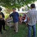 Larry Foley, a documentary filmmaker and University of Arkansas professor, center, and photographer ...