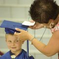 Brooks Harrison gets his cap adjusted by his mother Shannon Harrison on Monday before commencement c...