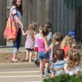 Caitlyn Beattie at Butterflies and Frogs Day Care in Springdale escorts children to the playground o...
