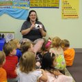 Kacey Morris works with children at the Butterflies and Frogs Day Care in Springdale on Monday.