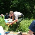 Matt Frye, a Pea Ridge National Military Park ranger, guides the basket Janis Boydston is lying in T...