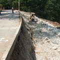 Dwayne Allen, Eureka Springs public works director looks Wednesday from Spring Street toward damage ...