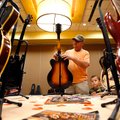 While his guitar is being appraised, Mike Curry of Fayetteville looks Wednesday at a Gretsch Electro...