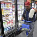 Rolland Myers of Decatur grabs a half-gallon of milk Wednesday at the new Walmart Express store in G...