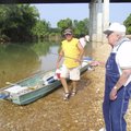 Jeff Fletcher, left, watches his dad, longtime guide J.D. Fletcher, fish at the U.S. 62 bridge acces...