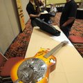 Casey Julseth, left, takes a look Wednesday at a violin and guitar owned by Bryan Loving of Lowell a...