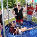 DENTIST DUNK Jessica Robinson, 9, center, laughs as she is dunked Thursday in a dunk tank as friend ...