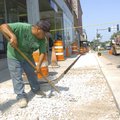 DOWNTOWN FACELIFT Abel Perea prepares the bed of a sidewalk on West Walnut Street on Thursday in dow...