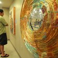 ARTS CENTER RECEPTION Josh Richardson of Fayetteville looks at art by Matt Miller on Thursday at the...