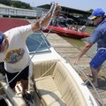 ON THE WATER Terry Wedel, right, of Rogers helps his brother Virgil Wedel of Canton, Kan., tie his b...