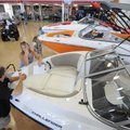 Marty Anderson, left, salesman at Bradford Marine, shows Jessica Wood, of Elkins, a few boats Wednes...