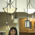 Rocio Larios-Ross, salesperson at Encore Flooring & Building Products in Springdale, talks to a supp...