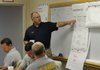 J.R. Alcorta, a mitigation consultant with the Federal Emergency Management Agency, speaks Wednesday at the agency’s disaster recovery center inside the Washington County Operations and Maintenance Building in Fayetteville.
