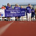 SURVIVOR LAP Cancer survivors take a solo “survivor lap” on Friday around Joe Roberts Track with Str...
