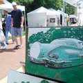 ARTSFEST AMBLE Visitors to the Downtown Bentonville’s Artsfest walk Saturday by one of Catherine Bol...