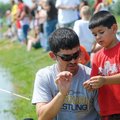 FISHING DERBY FUN Bobby Ortiz, left, works with son Blaine, 5, baiting a hook Saturday during the Fr...