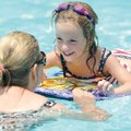 SATURDAY SWIM Lyndsey Nielsen, 5, right, smiles at her mother, Carrey Nielsen of Fayetteville, as th...