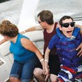 FAMILY FUN Patrick Cheney of Springdale, right, enjoys a boat ride Saturday on Beaver Lake with fami...