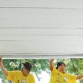 RESTORATIVE WORK Debra Lamm, left, and daughter Chaz Gogel paint the front porch of Marisela Muro’s ...