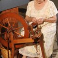 Wool and Wheel Guild member Patty Snell, 79, powers her spinning wheel with bare feet while making y...
