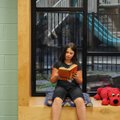 Maya Hall, 10, reads a book in the newly renovated library at Washington Elementary School in Fayett...