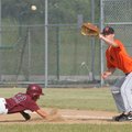 Heritage first baseman Jayme Lovelace stops a Lincoln attempt to steal second base in a NWA Wood Bat...