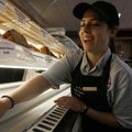 Marisa Grippo of Fayetteville cleans the pastry case at RZ’s Coffee House in the University of Arkan...