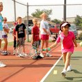 Tennis instructor Jill Eng, left, watches as Stephanie Sandoval, 7, coordinates hands, eyes and feet...