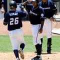 Northwest Arkansas’ Jamie Romak is congratulated by Salvador Perez as he crosses home plate after Ro...